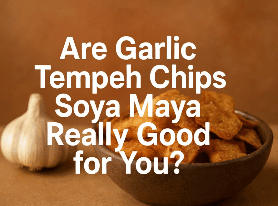 Crispy garlic tempeh chips with Soya Maya flavor, served in a rustic bowl on a wooden surface with garlic bulb in the background, highlighting a healthy, flavorful snack option.