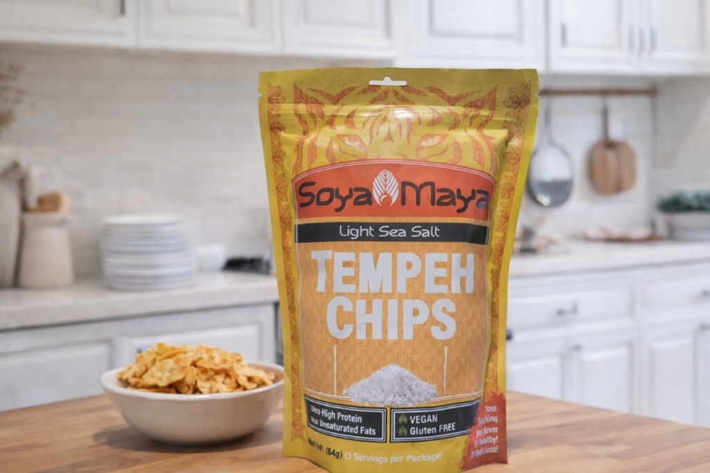 How is small-batch tempeh made shown through packaged tempeh chips on a kitchen counter with a bowl of chips nearby