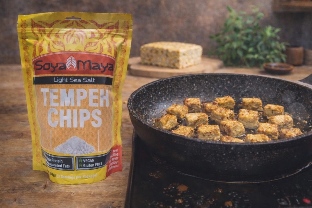 What does fresh tempeh taste like when cooked, showing pan-fried tempeh cubes with golden crust beside tempeh chips