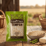 Pack of Soya Maya Tempeh with fresh slices on a wooden table.