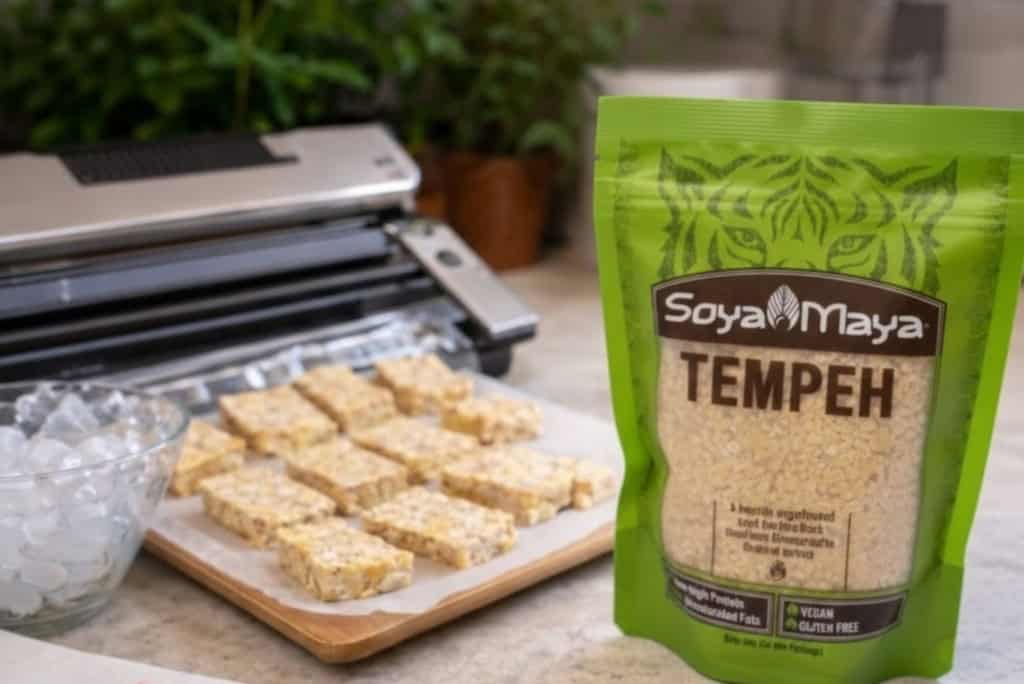 Organic Soya Maya Tempeh in green packaging on kitchen countertop.