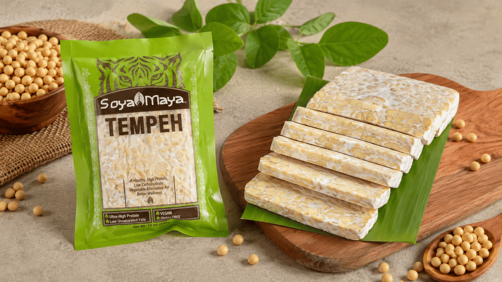 Sliced SoyaMaya tempeh block on wooden board, what are the benefits of non-gmo soy made into tempeh