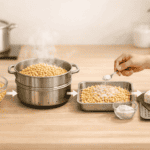 Understanding tempeh processing methods: soybeans steamed and mixed with starter culture on a kitchen counter. 