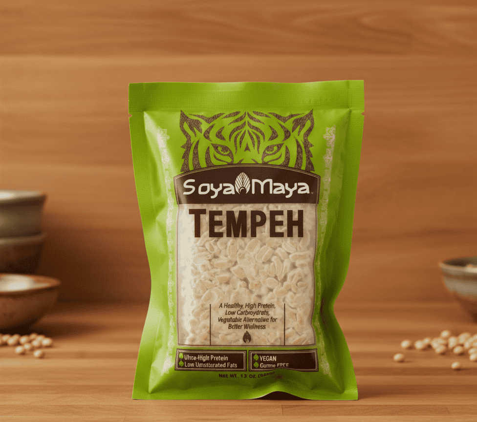 Green SoyaMaya Tempeh standup pouch displaying what is rhizopus oligosporus culture fermented soybeans on wooden surface, vegan, gluten free